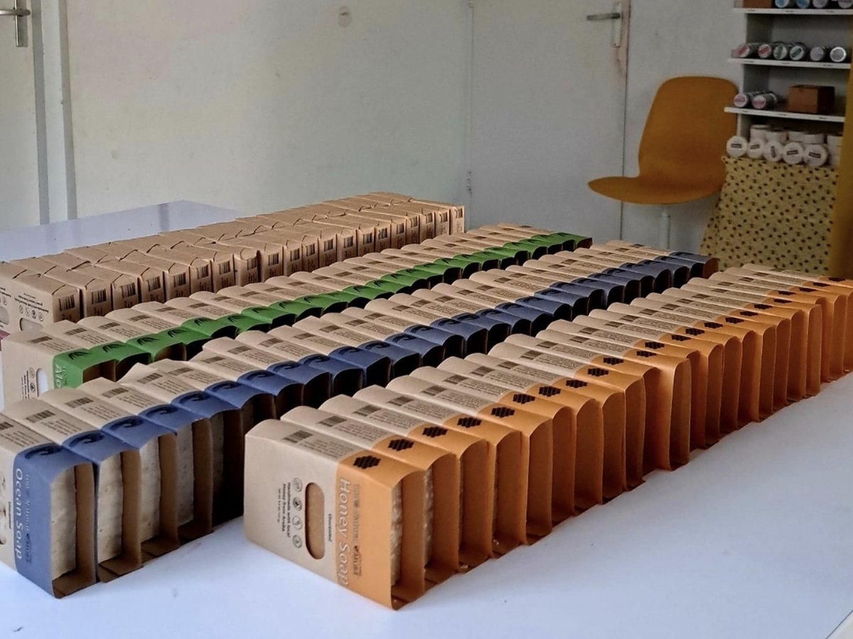 Rows of Ocean Soap, Honey Soap, and Aloe Soap boxes stacked and ready for restocking at Eco Living Aruba